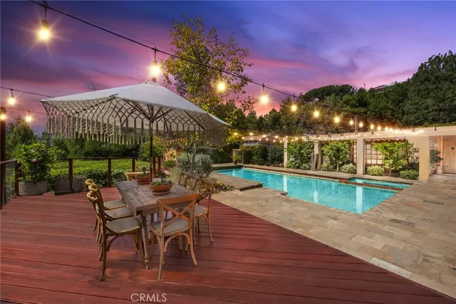 a view of a chairs and table in patio with a lake view