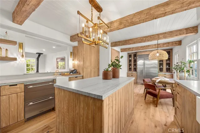 a bathroom with a granite countertop sink a toilet and a shower