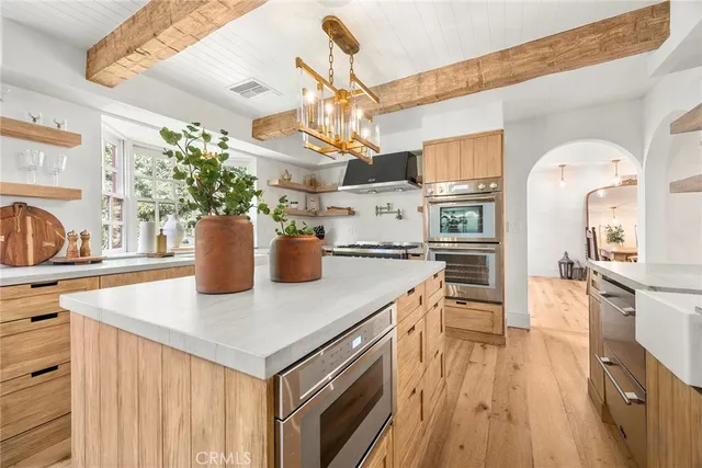 a living room with furniture and large windows