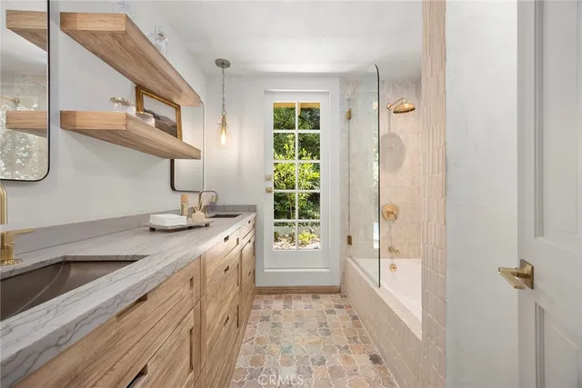 a view of a patio with couches chairs and floor to ceiling window with outer view