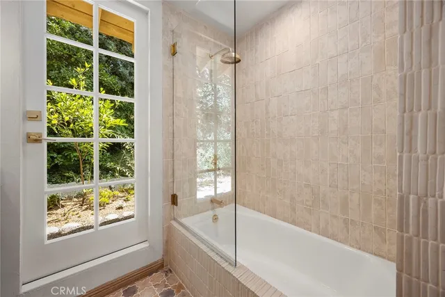 a view of backyard with barbeque grill and wooden fence