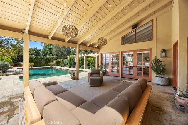 a view of a patio with furniture and umbrella
