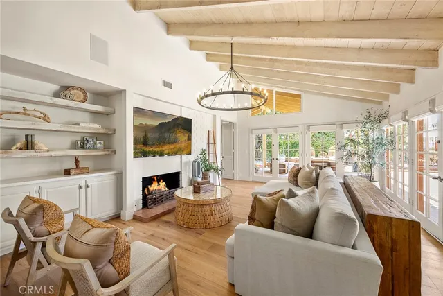 a living room with furniture a table and kitchen view