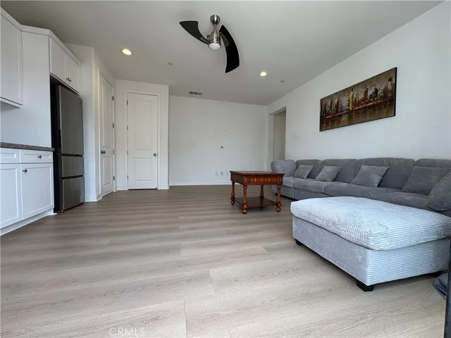 a living room with furniture and a ceiling fan