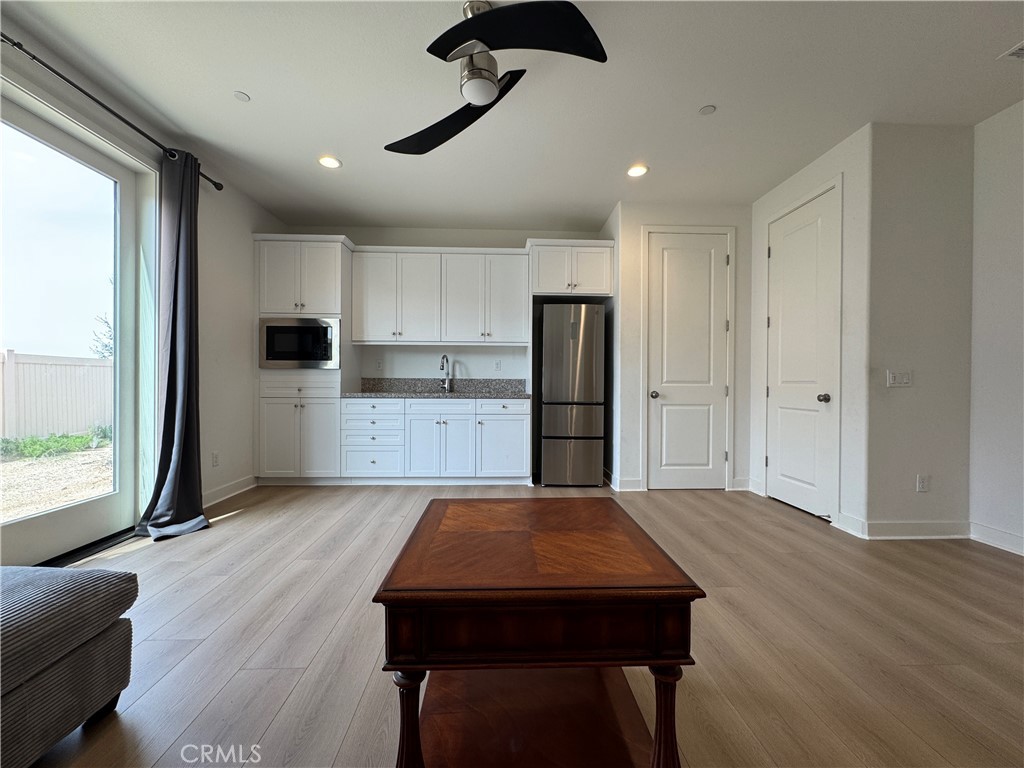 13562 Pointer Court Riverside, CA 92503 - Photo 13 of 42 a kitchen with stainless steel appliances granite countertop a refrigerator a stove and a wooden floors