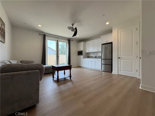 a living room with furniture and a kitchen