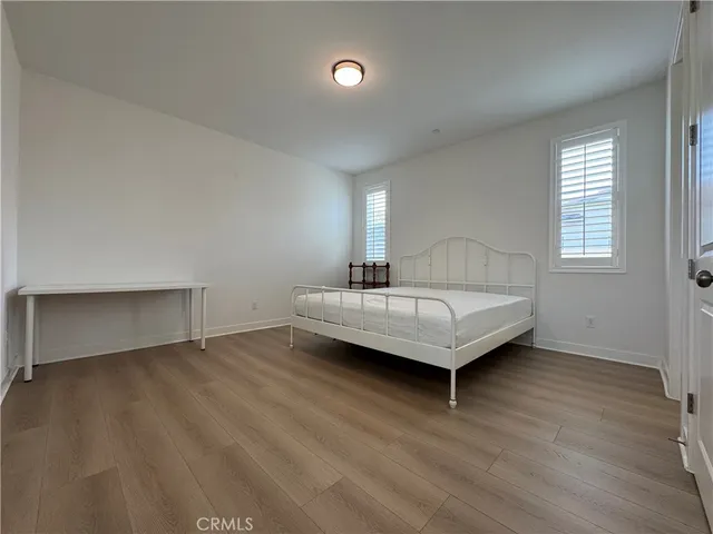 a view of a room with a window and wooden floor