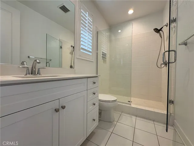 a bathroom with a toilet sink and shower