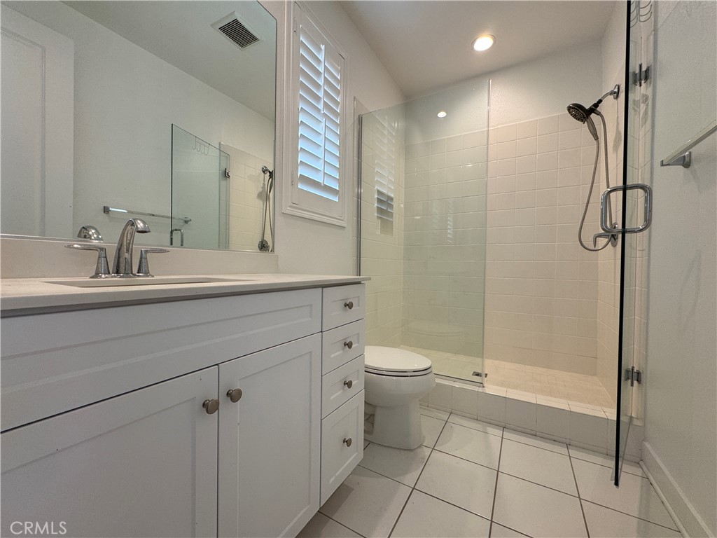 13562 Pointer Court Riverside, CA 92503 - Photo 19 of 42 a bathroom with a toilet sink and shower