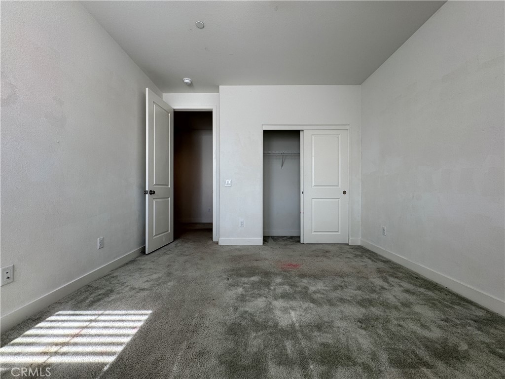 13562 Pointer Court Riverside, CA 92503 - Photo 23 of 42 an empty room with windows and closet