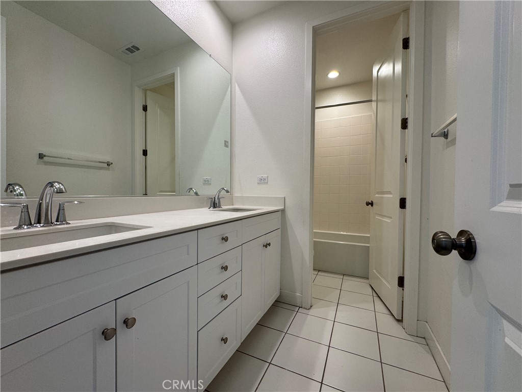 13562 Pointer Court Riverside, CA 92503 - Photo 25 of 42 a bathroom with a double vanity sink mirror and toilet