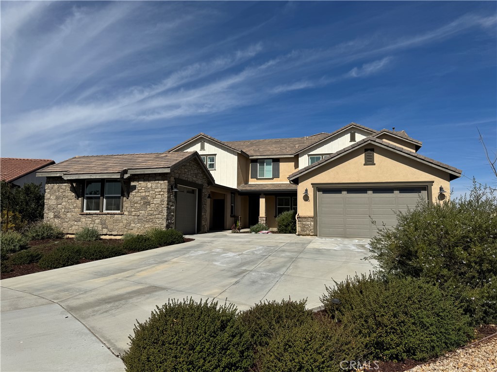 13562 Pointer Court Riverside, CA 92503 - Photo 3 of 42 a front view of a house with a yard and garage