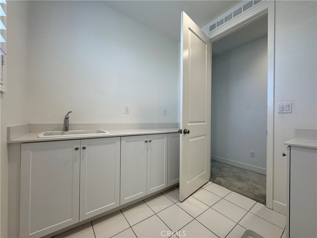 13562 Pointer Court Riverside, CA 92503 - Photo 31 of 42 a view of a kitchen with white cabinets