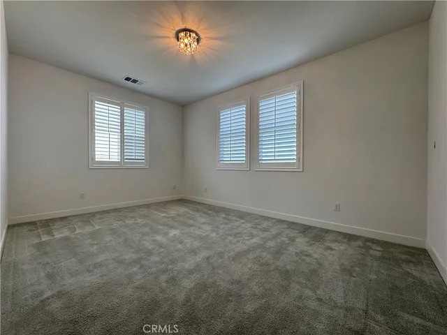 an empty room with a empty space and windows