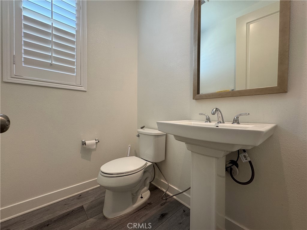 13562 Pointer Court Riverside, CA 92503 - Photo 42 of 42 a bathroom with a sink toilet and a mirror