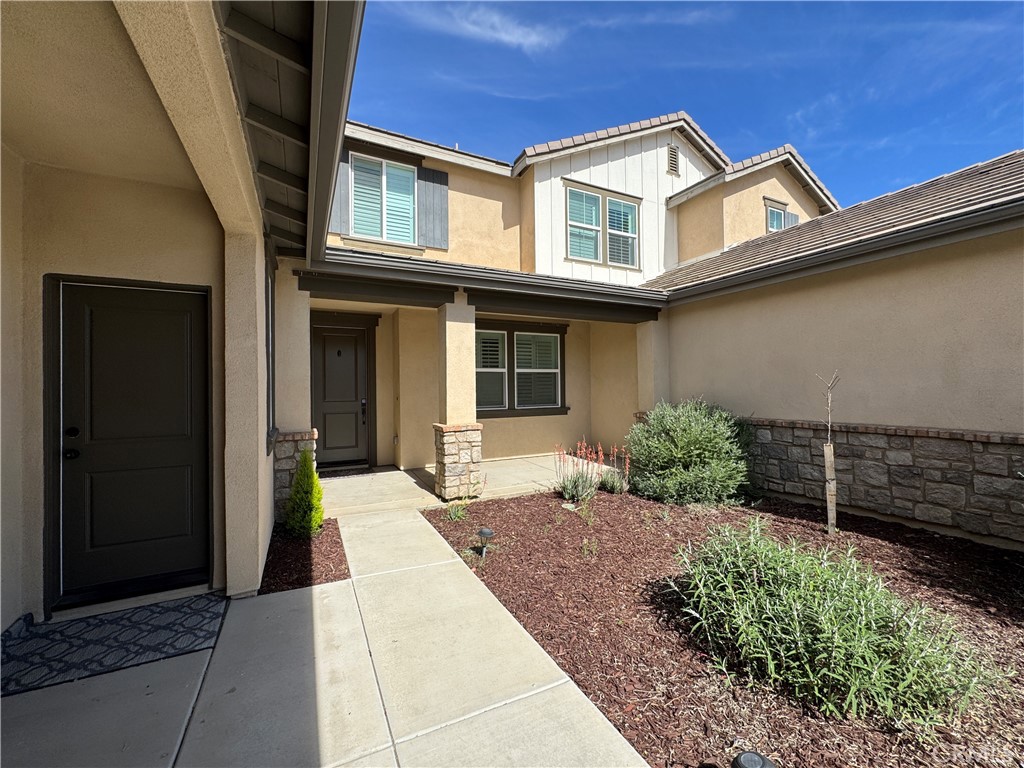 13562 Pointer Court Riverside, CA 92503 - Photo 5 of 42 a front view of a house with a garden