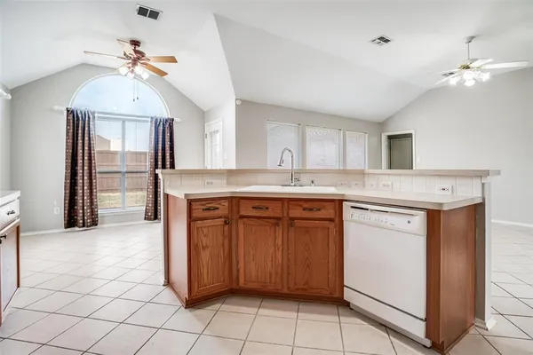 a kitchen with a sink cabinets and window