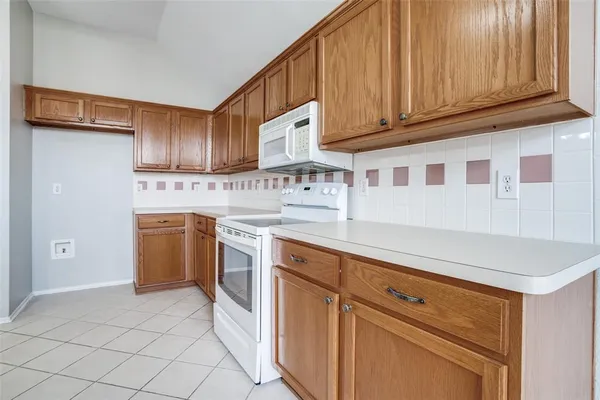 a kitchen with cabinets and appliances