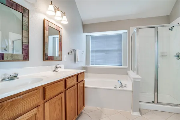 a bathroom with a tub sink and mirror