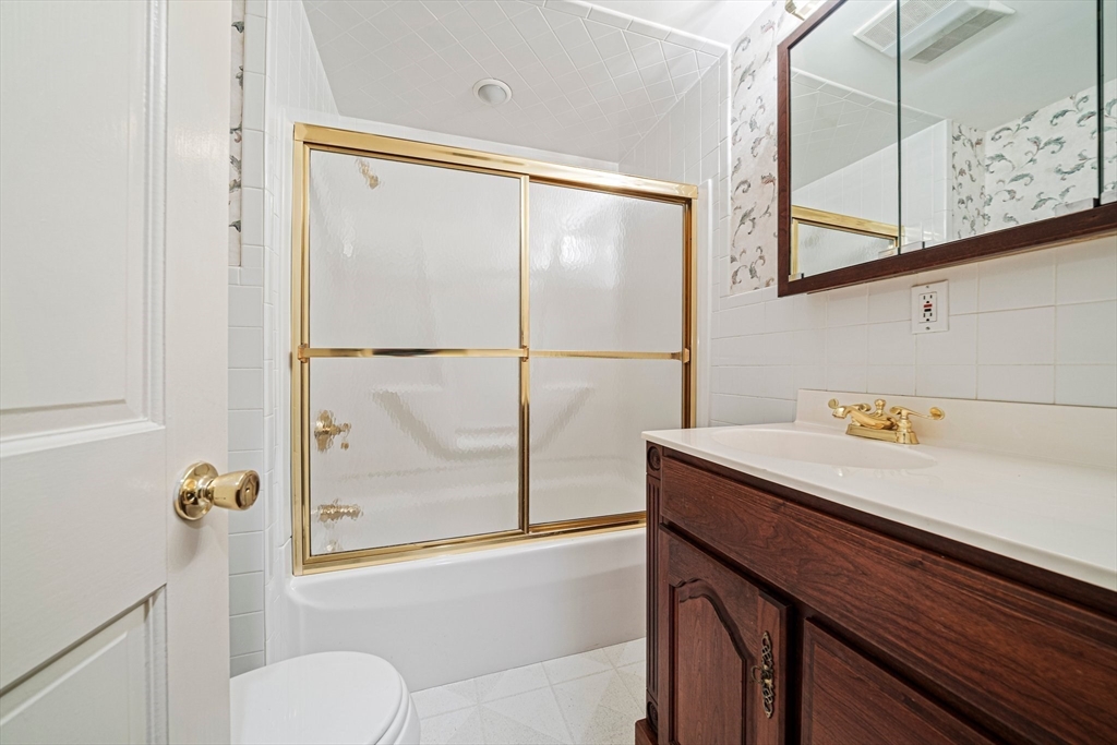 1032 Washington Street Canton, MA 02021 - Photo 15 of 42 a bathroom with a sink and a mirror