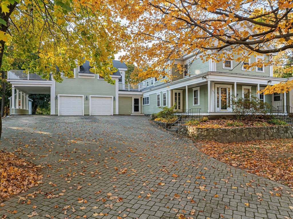 1032 Washington Street Canton, MA 02021 - Photo 2 of 42 a front view of a house with a garden