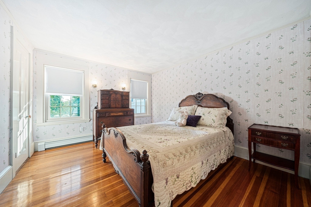 1032 Washington Street Canton, MA 02021 - Photo 27 of 42 a bedroom with a bed and a view of kitchen