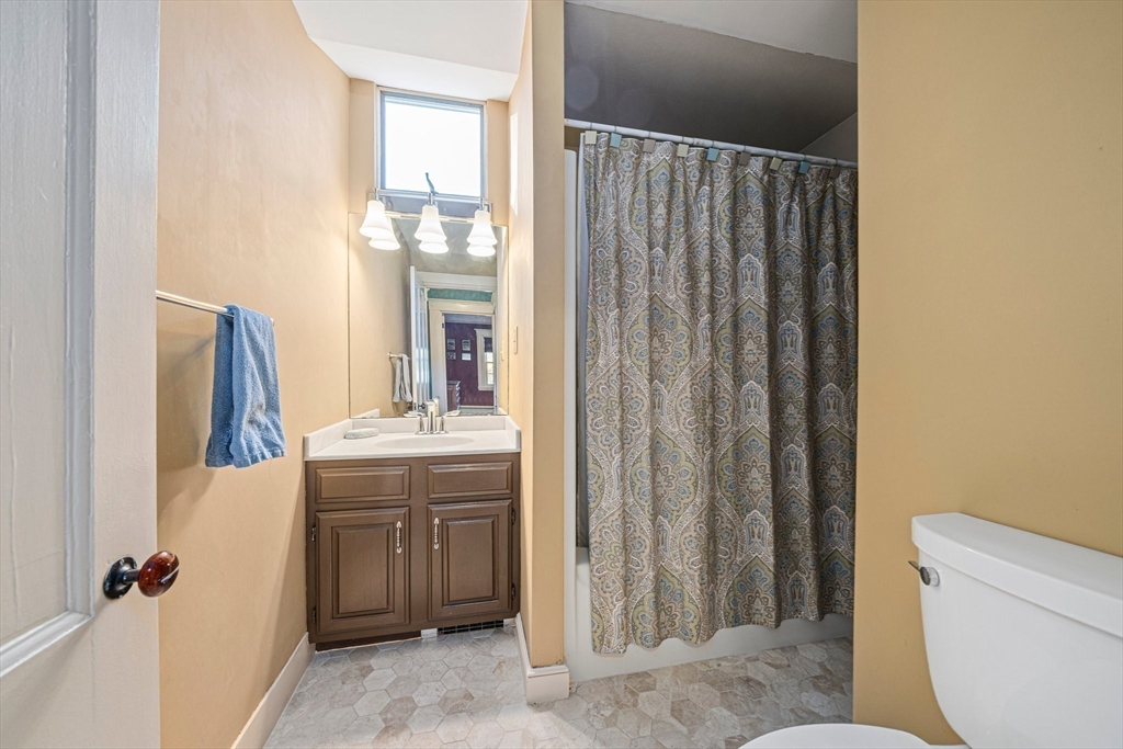 1032 Washington Street Canton, MA 02021 - Photo 29 of 42 a bathroom with a granite countertop sink and a mirror
