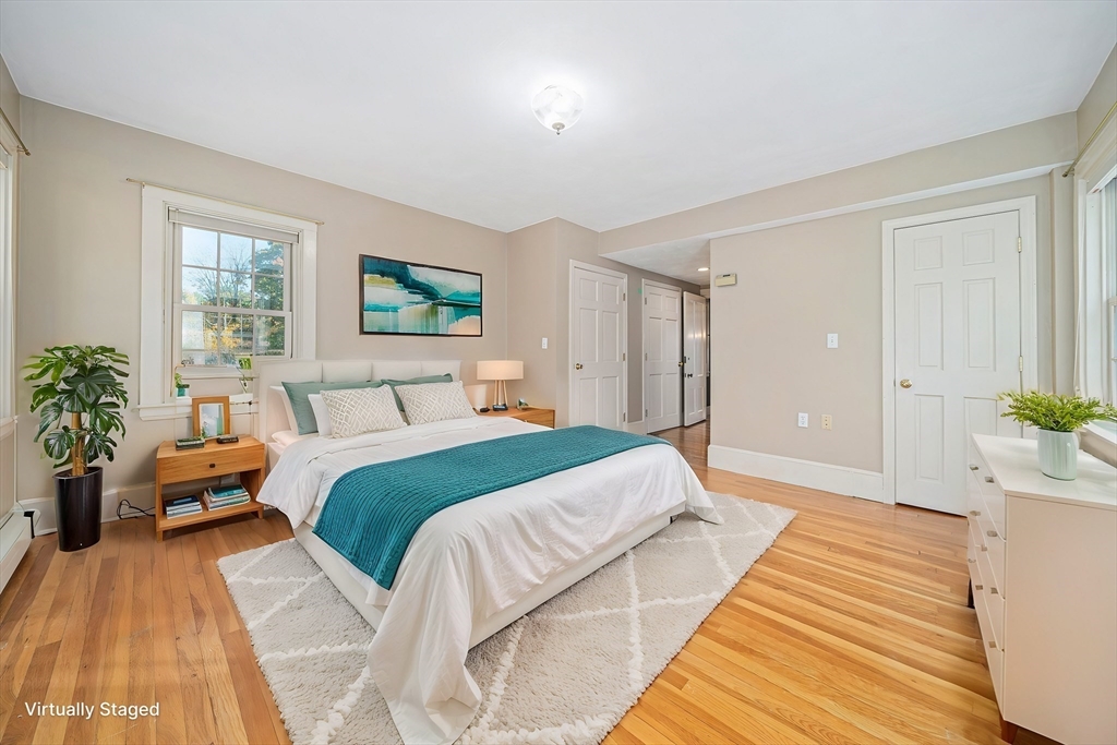 1032 Washington Street Canton, MA 02021 - Photo 30 of 42 a bedroom with a large bed and a potted plant