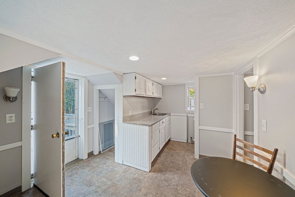 1032 Washington Street Canton, MA 02021 - Photo 37 of 42 a kitchen with a sink and a refrigerator