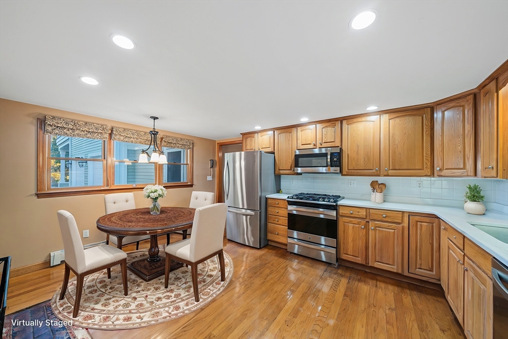 1032 Washington Street Canton, MA 02021 - Photo 4 of 42 a kitchen with stainless steel appliances kitchen island granite countertop a sink and cabinets