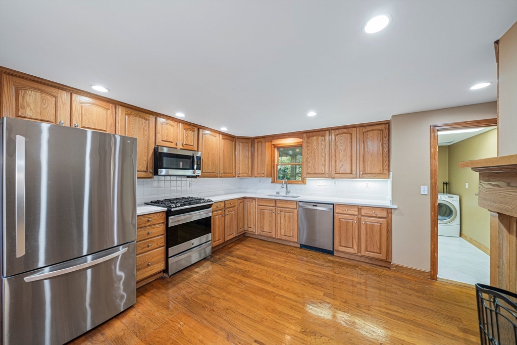 1032 Washington Street Canton, MA 02021 - Photo 5 of 42 a kitchen with granite countertop a refrigerator stove top oven and sink