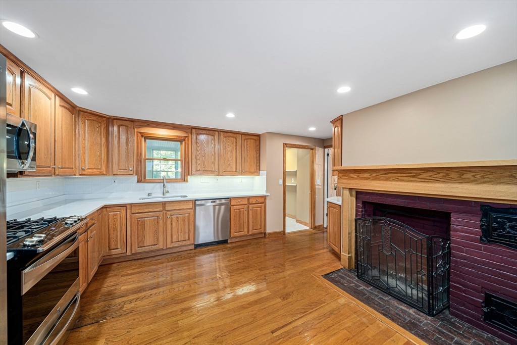 1032 Washington Street Canton, MA 02021 - Photo 6 of 42 a large kitchen with stainless steel appliances granite countertop a stove a sink and a white cabinets