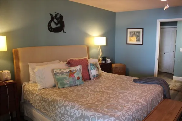 a large bed sitting in a bedroom next to a window