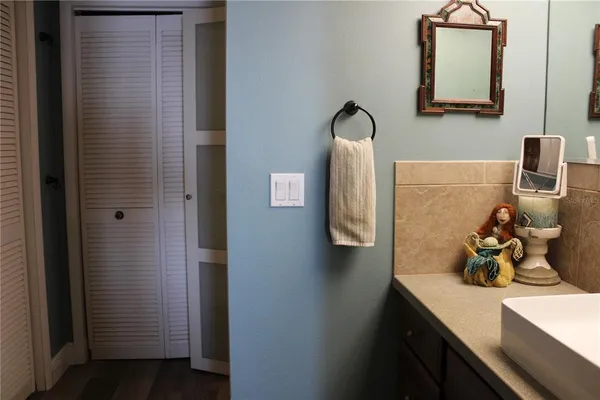 a bathroom with a granite countertop sink and a mirror