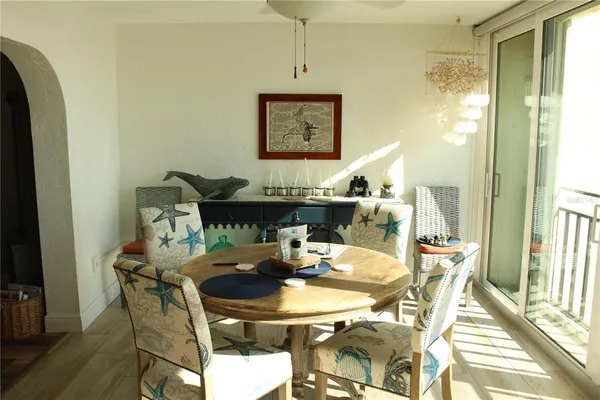 a view of a patio with table and chairs and a tree