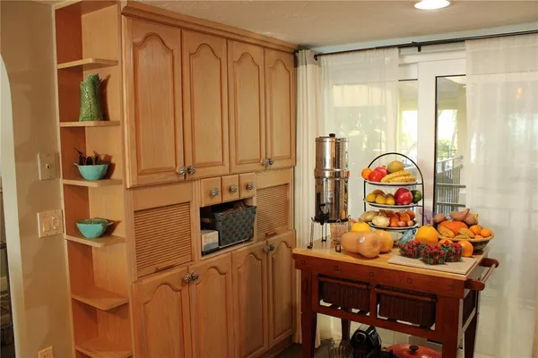 a living room with furniture fireplace and a large window