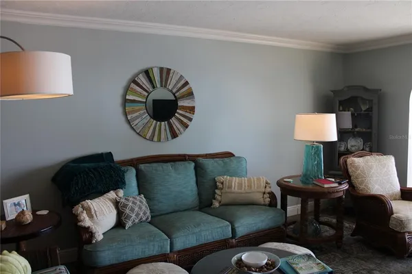 a bed room with a bed and painting on the wall