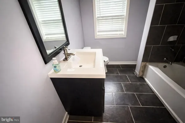 a bathroom with a sink toilet and tub