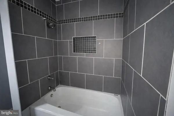 a bathroom with a bathtub and shower