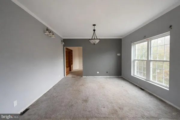 a view of a livingroom with a ceiling fan and window
