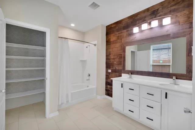 a bathroom with a granite countertop sink mirror and