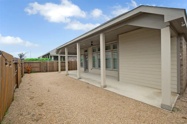 a view of a house with a wooden fence