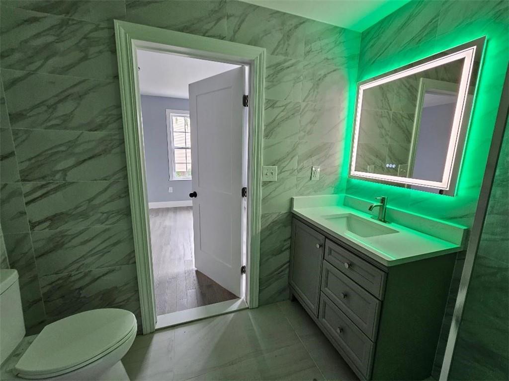 477 Connecticut Avenue Rochester, PA 15074 - Photo 11 of 17 a bathroom with a toilet sink and mirror