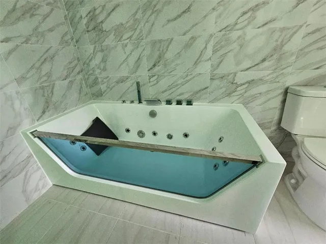 a bathroom with a sink a mirror and shower