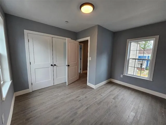 a view of an empty room with wooden floor