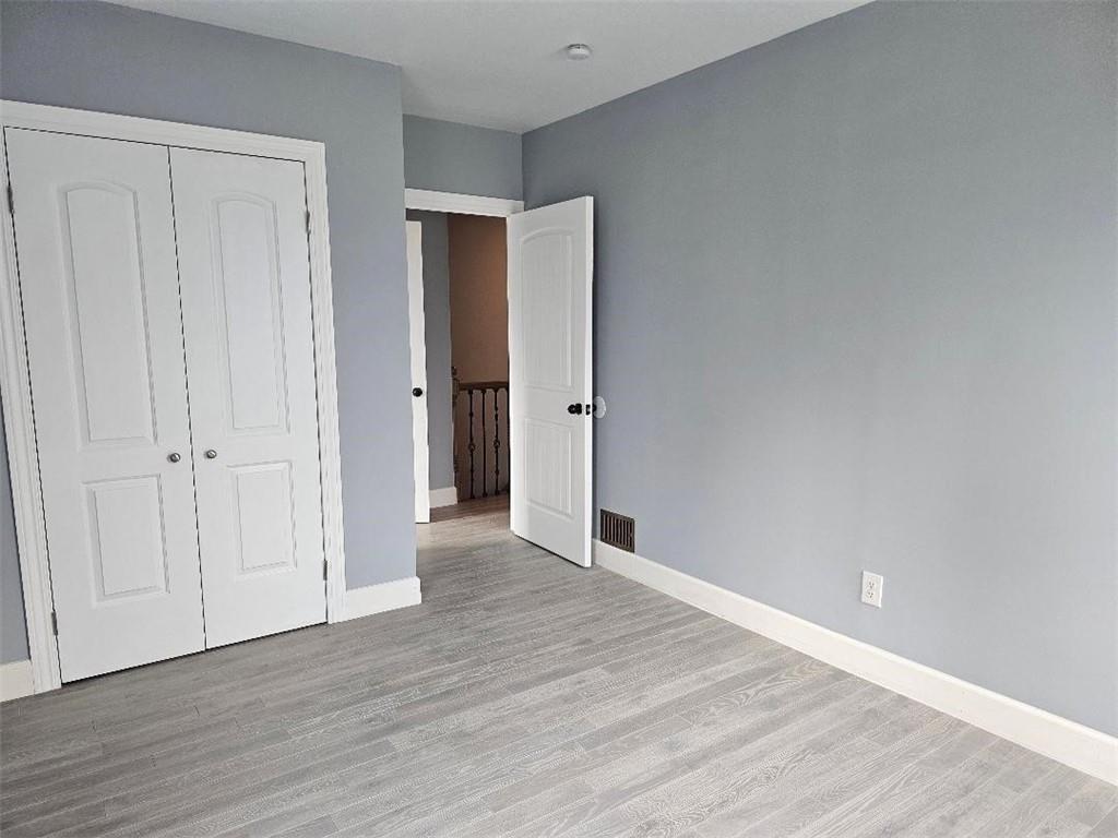 477 Connecticut Avenue Rochester, PA 15074 - Photo 16 of 17 a view of an empty room with wooden floor