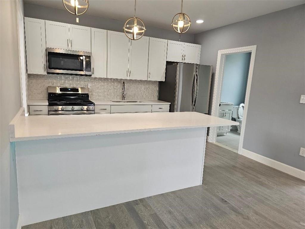 477 Connecticut Avenue Rochester, PA 15074 - Photo 3 of 17 a kitchen with kitchen island a refrigerator stove and microwave