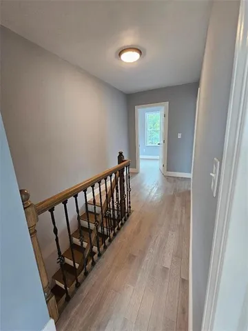 a view of hallway with wooden floor