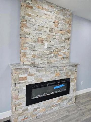 wooden floor in an empty room with a fireplace