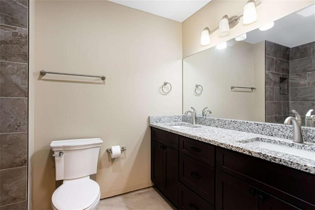 3721 Bogan Mill Road Northeast Buford, GA 30519 - Photo 49 of 58 a bathroom with a granite countertop sink toilet and a mirror